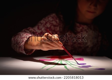 Hobby, art and childhood concept. Happy young girl learn to draw. Selective focus on hand. 