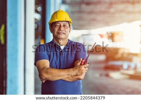 southeast asian male worker foreman standing portrait smile with radio control loading cargo shipping industry Royalty-Free Stock Photo #2205844379
