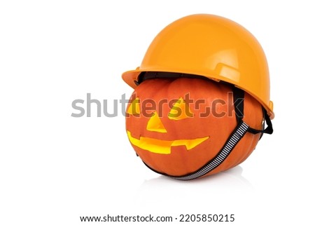Halloween, orange pumpkin with yellow construction helmet, hard hat. White background.