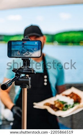 man chef gives an interview for a video blog outdoor