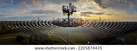 Graphical representation of radio waves ripples around 5G cell phone tower on a park hill in Lexington, Kentucky