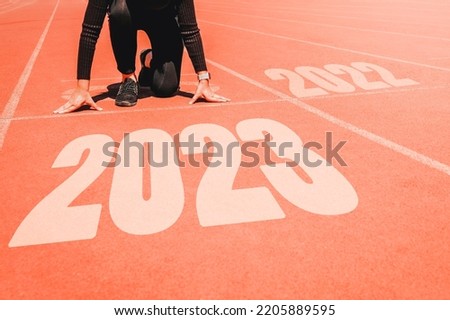 2023 Newyear , Athlete Woman starting on line for start running with number 2020 Start to new year. Royalty-Free Stock Photo #2205889595