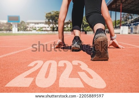 2023 Newyear , Athlete Woman starting on line for start running with number 2020 Start to new year. Royalty-Free Stock Photo #2205889597