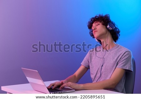 gamer cyberspace playing with headphones in front of a laptop isolated background