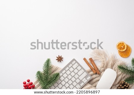 Christmas Day concept. Top view photo of keyboard computer mouse pine cone fir branches cinnamon sticks mistletoe dried citrus slices cozy knitted plaid on isolated white background with empty space