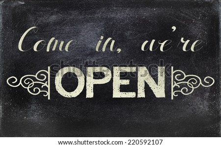 Image of a blackboard sign, stating OPEN.