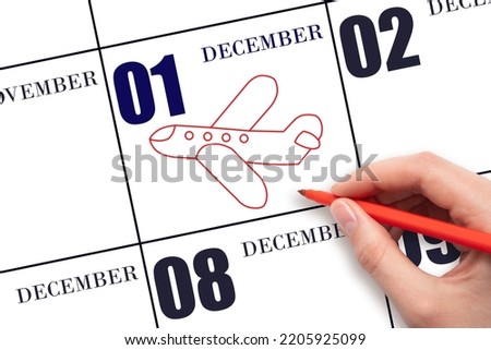 1st day of December. A hand drawing outline of airplane on calendar date 1 December. The date of flight on plane. Travel, business trips. Winter month. Day of the year