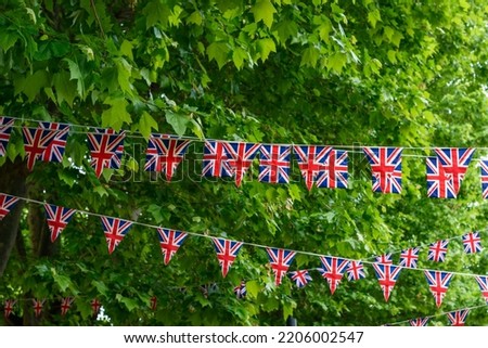 British Union Jack flag triangular hanging in preparation for a street party. Festive decorations of Union Jack bunting. Selective focus 