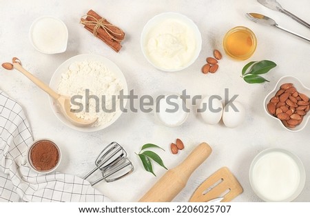 Kitchen background for baking and cooking cake,bread,confectionery and ingredients for cooking,milk,honey,flour,salt,sugar,eggs and cream on concrete background,selective focus,