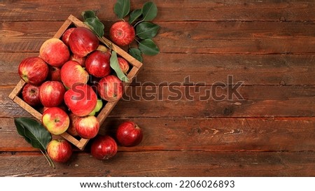 Apples in a box on a sunny wooden table, thanksgiving background, harvesting, healthy natural food concept, detox diet and body cleansing, screen banner, cafe, restaurant,