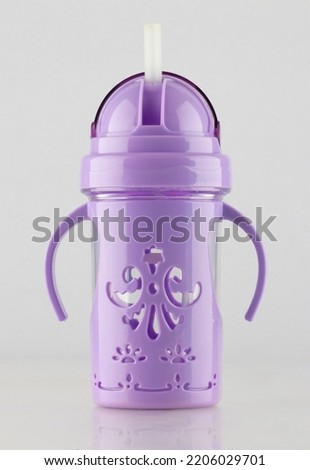 A colorful water bottle for children with a straw, purple color, white background, open bottle