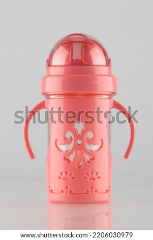 A colorful water bottle with a straw, pink color, white background