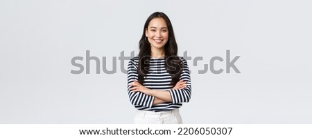Lifestyle, people emotions and casual concept. Confident nice smiling asian woman cross arms chest confident, ready to help, listening to coworkers, taking part conversation Royalty-Free Stock Photo #2206050307