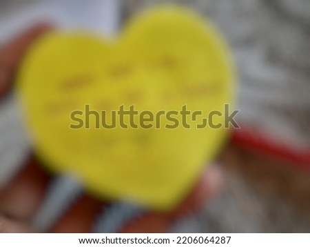 Defocused or blurred abstract background of a yellow note