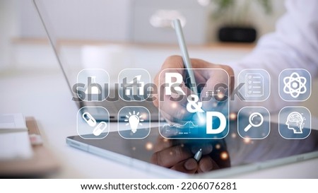 Hand of businessman holding a pen pointing to R and D icon for Research and Development on laptop screen. Manage costs more efficiently. R and D innovation concept. Royalty-Free Stock Photo #2206076281