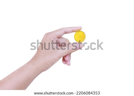One man's hand was holding a gold coin with a finger. isolated on a white background
