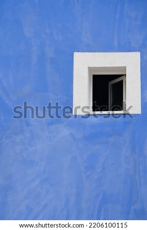 Colorful blue colored facade with window details on a Latin Colonial building. architecture and construction concept