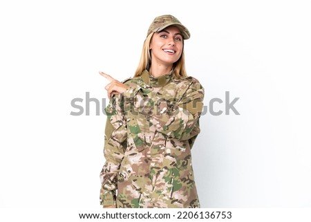 Military woman isolated on white background pointing to the side to present a product