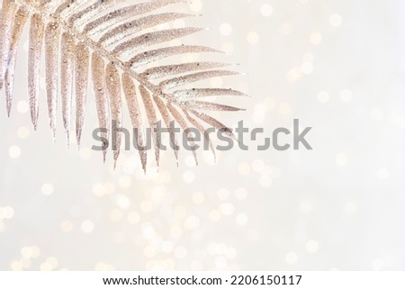 Shiny gradient background with golden palm leaf and bokeh.