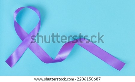 Purple ribbon on blue background ADD,ADHD,Alzheimer Disease ,Arnold Chiari Malformation,Childhood Hemiplegia stroke, Epilepsy, Chronic Acute Pain,Crohns Royalty-Free Stock Photo #2206150687