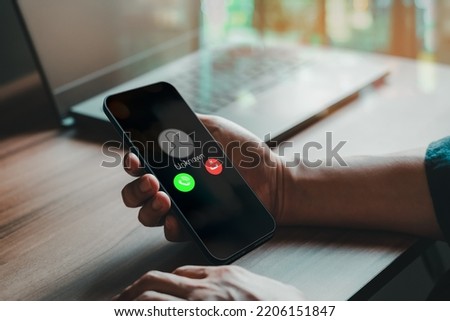 Man answering to incoming call. Phone call from unknown number. Call center gang, scammer or stranger. Hoax person with fake identity. Scam, fraud or phishing with mobile phone or smartphone concept. Royalty-Free Stock Photo #2206151847