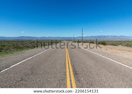 freeway in the Mohave valley in Arizona, USA with mountains at horizon Royalty-Free Stock Photo #2206154131