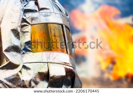 Fireman in special heat resistant  protection suit. Professional protection against heat and open flame Royalty-Free Stock Photo #2206170445