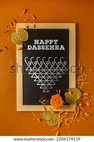 ‘Happy Dussehra’ photo or greeting card with message in English. Hindu religious symbol with message to celebrate Dussehra festival. Royalty-Free Stock Photo #2206174119