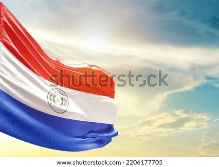 Paraguay national flag waving in beautiful sky.
