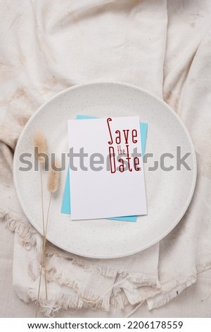 Wedding card mockup. a card that says save the date. card on a white plate. wedding card. Top view
