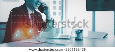 Futuristic businessman having phone call with business sale chart