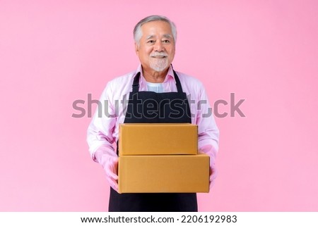 retired asian elderly man smiling holding paper box package online marketing and delivery business, Old elderly male delivery shipping service concept.