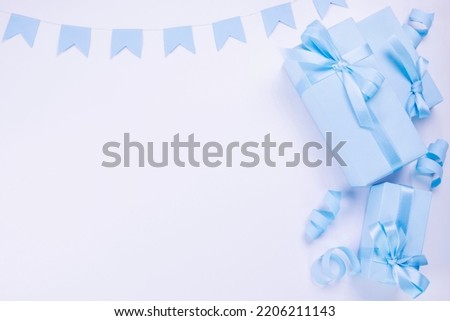 blue gift boxes with blue bows template for copy pasting, postcard, concept for celebrating a boy or man's birthday, party, anniversary or newborn. High quality photo