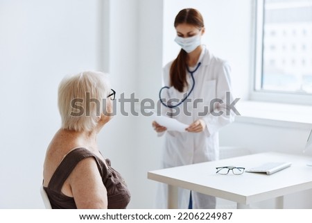 old woman patient on examination by a nurse medical office