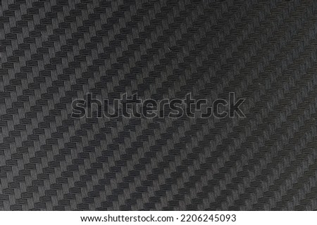 Composite material  dark color background. Carbon fiber texture