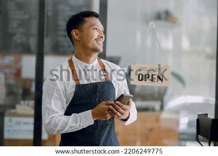 Asian Happy businessman and business owner standing in cafe.