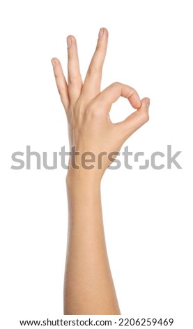 Woman showing okay gesture on white background, closeup of hand