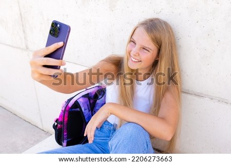Teenage girl making video call on mobile phone