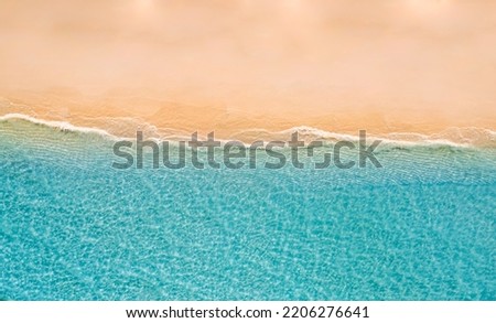 Summer seascape beautiful waves, blue sea water in sunny day. Top drone view. Sea aerial view, amazing tropical nature background. Beautiful bright sea waves surf on bright Mediterranean beach sand Royalty-Free Stock Photo #2206276641