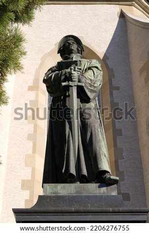 Bronze statue of reformer Ulrich Zwingli at the old town of Zurich on a beautiful late summer morning. Photo taken September 22nd, 2022, Zurich, Switzerland.