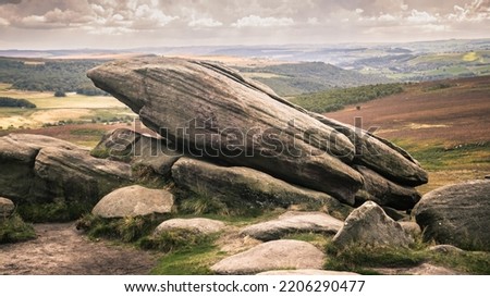 Higger Tor is a dominant landmark of the Dark Peak, in the north of the Peak District. It is a gritstone tor overlooking the Burbage Valley and the Iron Age hill fort of Carl Wark to the southeast Royalty-Free Stock Photo #2206290477