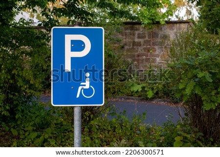 a street sign for handicap parking and trees