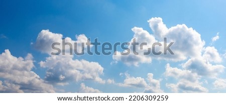Sunlit white clouds in the blue sky