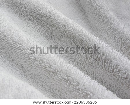 Towel texture closeup. Soft white cotton towel backdrop, fabric background. Terry cloth bath or beach towels. Soft fluffy Textile. Macro, texture Royalty-Free Stock Photo #2206336285