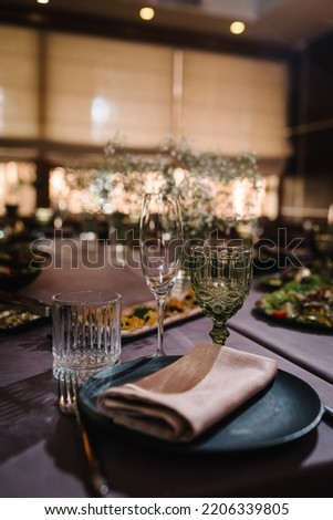 Closeup glasses and tableware for evening dinner party. Boho rustic banquet hall decorated served table. Birthday party, babyshower, bachelorette party, wedding, luxury style. Setting festive table. Royalty-Free Stock Photo #2206339805
