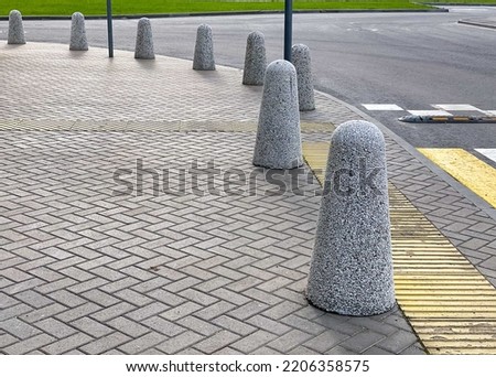 pedestrian crossing mark with speed bumps and guard posts in the city