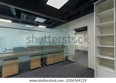 Spacious bright office space with glass door and partitions, ready to work.