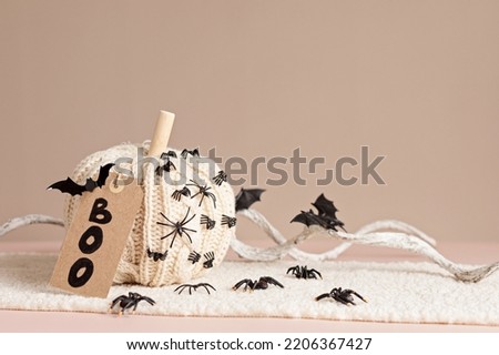 Modern interior decoration for halloween celebration with handmade knit pumpkin, spiders, bats 