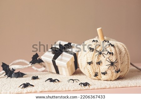 Modern interior decoration for halloween celebration with handmade knit pumpkin, spiders, bats and gift box