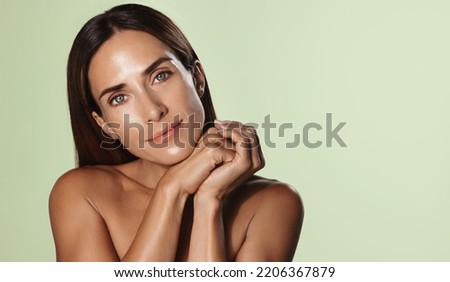 Beauty portrait of mature woman smiling with hand on face. Closeup face of happy adult, 40s years, woman feeling fresh after anti-aging treatment. Smiling beauty looking at camera with perfect skin. Royalty-Free Stock Photo #2206367879